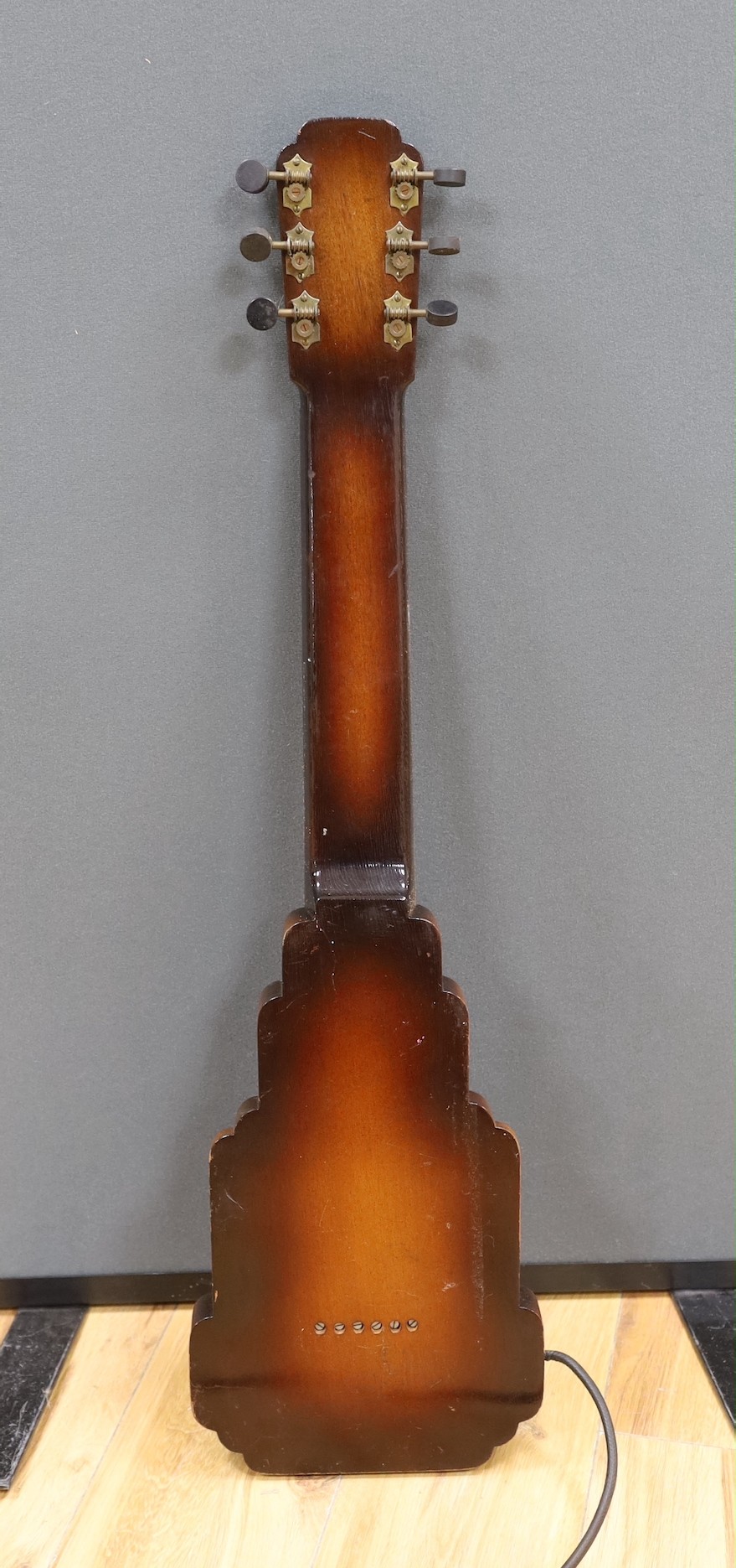 A steel guitar, the case, inscribed Haiwaians, 83cms high